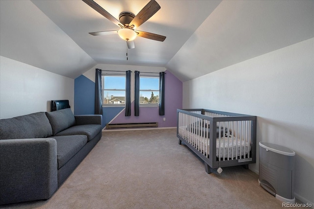 bedroom featuring ceiling fan, a baseboard heating unit, a crib, and lofted ceiling