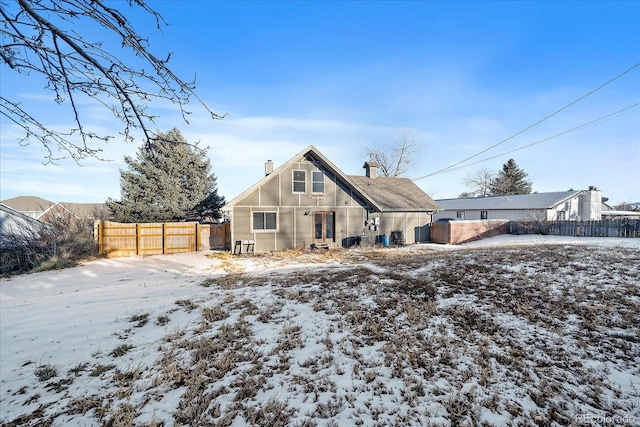 view of snow covered rear of property