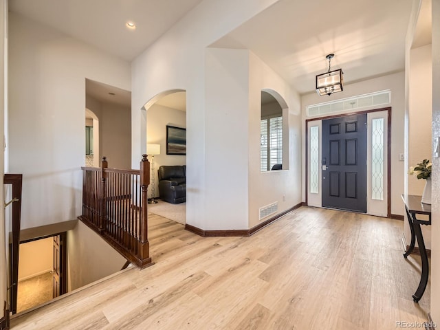 10050 Eagle Valley Way, Highlands Ranch, CO 80129 - foyer featuring wood finished floors, arched walkways, a chandelier, and recessed lighting