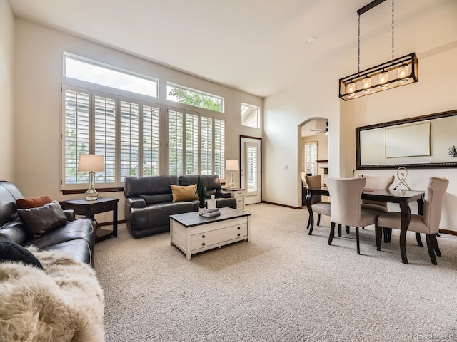 10050 Eagle Valley Way, Highlands Ranch, CO 80129 - living room featuring light carpet, a ceiling fan, and a high ceiling