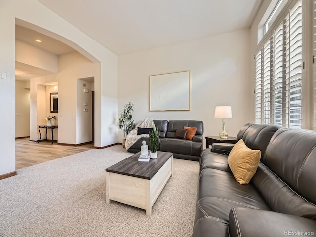 10050 Eagle Valley Way, Highlands Ranch, CO 80129 - living room with light carpet, arched walkways, and plenty of natural light