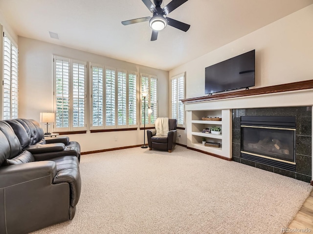 10050 Eagle Valley Way, Highlands Ranch, CO 80129 - living area featuring ceiling fan, a tiled fireplace, and carpet flooring