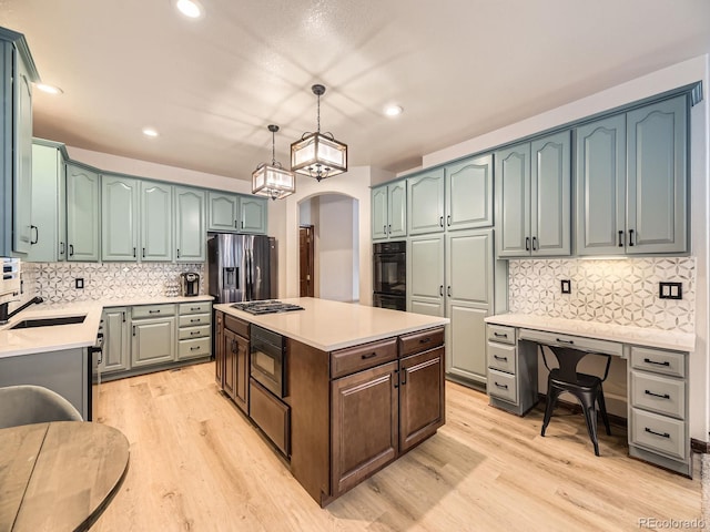 10050 Eagle Valley Way, Highlands Ranch, CO 80129 - kitchen with appliances with stainless steel finishes, a kitchen island, light wood-style floors, tasteful backsplash, and recessed lighting