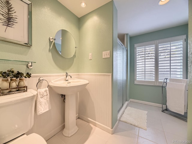 10050 Eagle Valley Way, Highlands Ranch, CO 80129 - bathroom featuring a shower stall, wainscoting, and tile patterned flooring