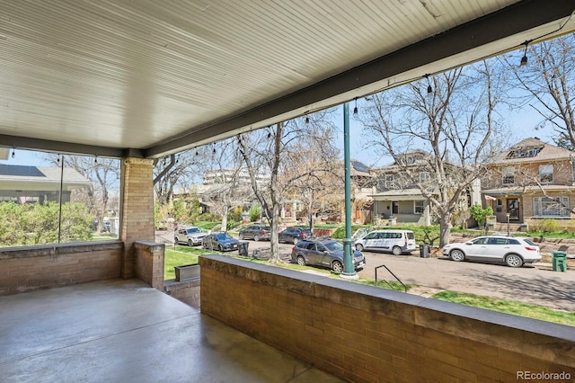view of patio featuring covered porch and a residential view