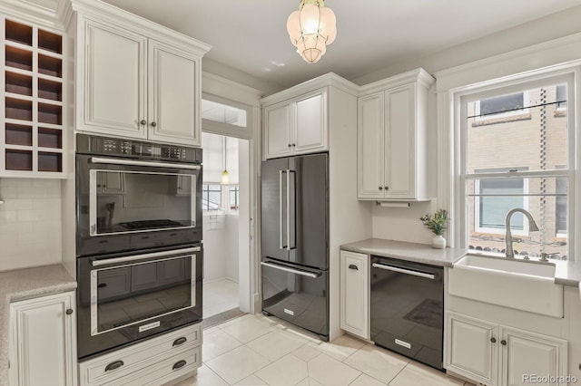 kitchen with decorative backsplash, a sink, black appliances, and a wealth of natural light