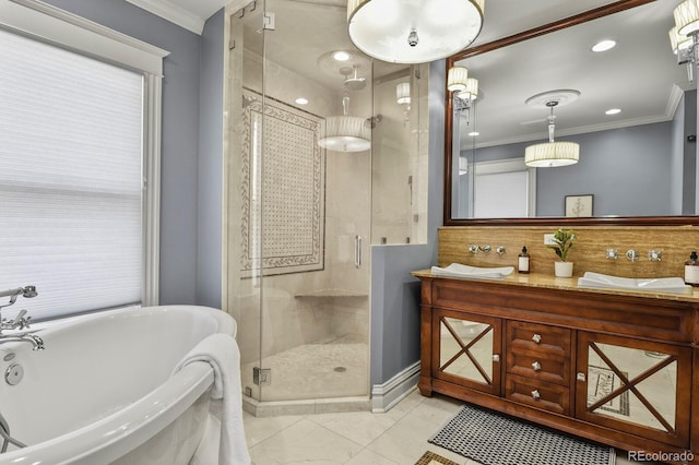 full bath featuring a stall shower, a soaking tub, a sink, and ornamental molding