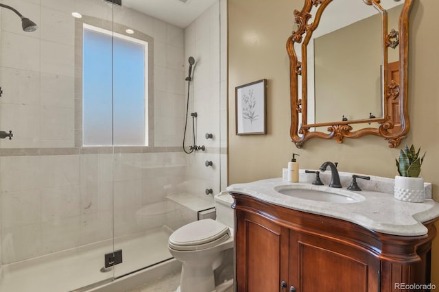full bath featuring toilet, a shower stall, and vanity