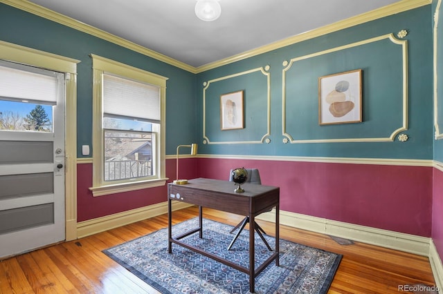office space featuring crown molding, baseboards, and hardwood / wood-style flooring
