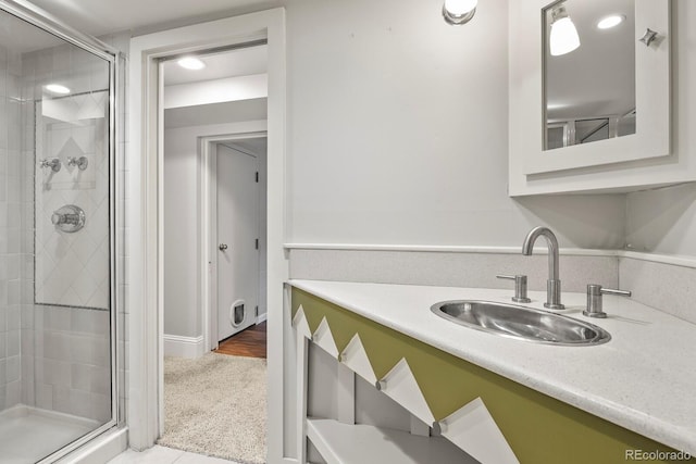 bathroom featuring a shower stall and vanity