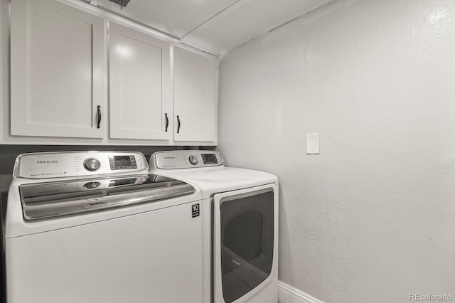 laundry area with cabinet space and washing machine and dryer
