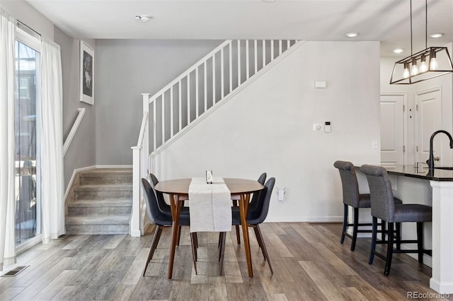 dining room featuring hardwood / wood-style flooring and sink