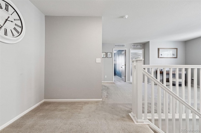 hall featuring light colored carpet