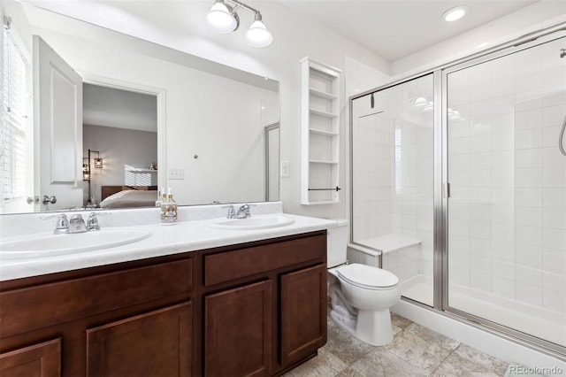 bathroom featuring vanity, toilet, and an enclosed shower