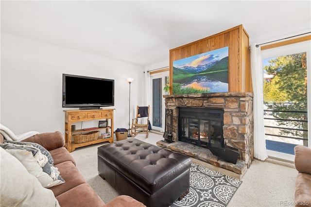 carpeted living area with a fireplace