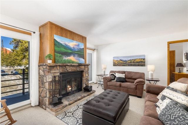 carpeted living room with a wealth of natural light and a fireplace