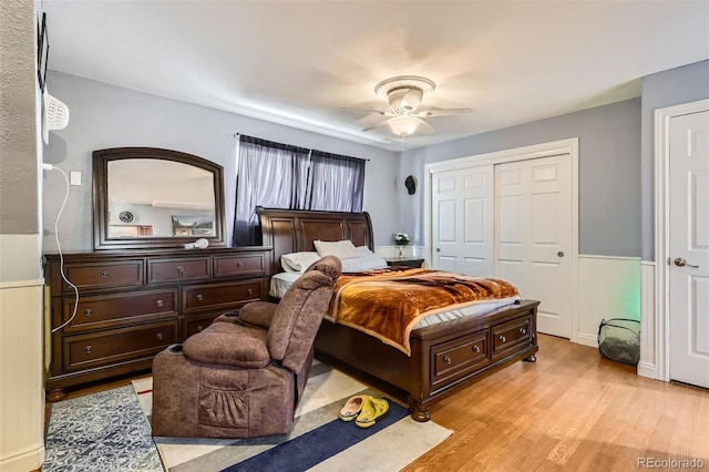 bedroom featuring ceiling fan, a closet, and light hardwood / wood-style flooring