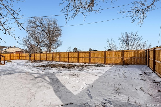 view of yard layered in snow