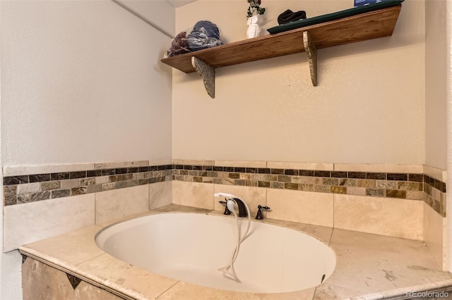 bathroom featuring tiled tub