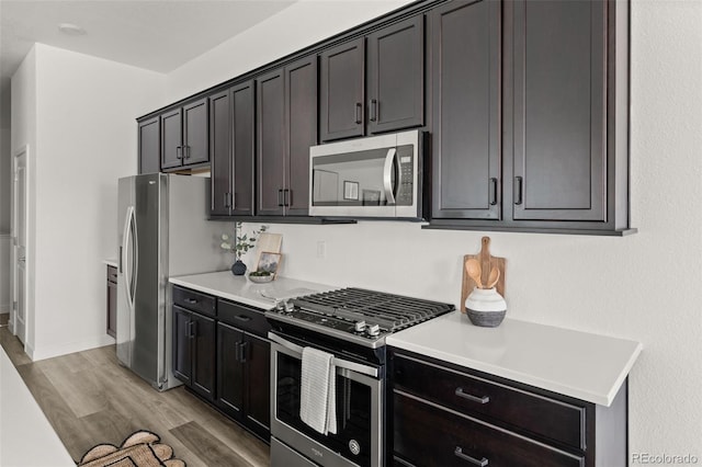12547 Lake View St, Longmont, CO 80504 - kitchen with appliances with stainless steel finishes, light wood-style flooring, light countertops, and baseboards