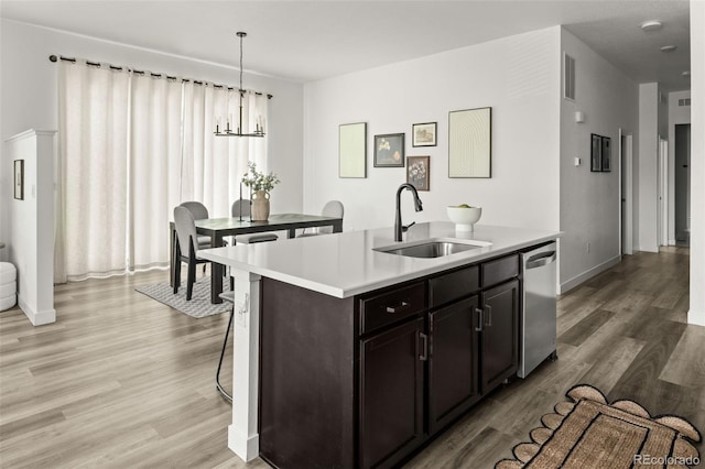 12547 Lake View St, Longmont, CO 80504 - kitchen featuring a sink, dishwasher, a chandelier, light countertops, and light wood-style floors