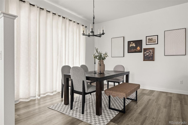 12547 Lake View St, Longmont, CO 80504 - dining area featuring a chandelier, wood finished floors, and baseboards