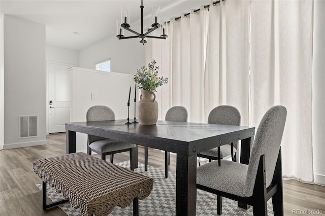 12547 Lake View St, Longmont, CO 80504 - dining space with a chandelier, light wood-type flooring, and baseboards