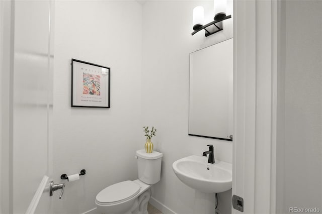 12547 Lake View St, Longmont, CO 80504 - bathroom featuring baseboards, toilet, and a sink