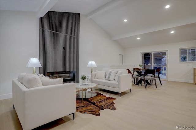 living room with lofted ceiling with beams and light hardwood / wood-style floors