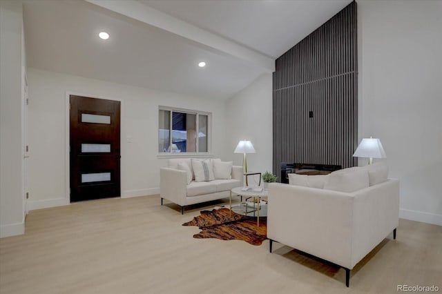 living room with light wood-type flooring and vaulted ceiling with beams