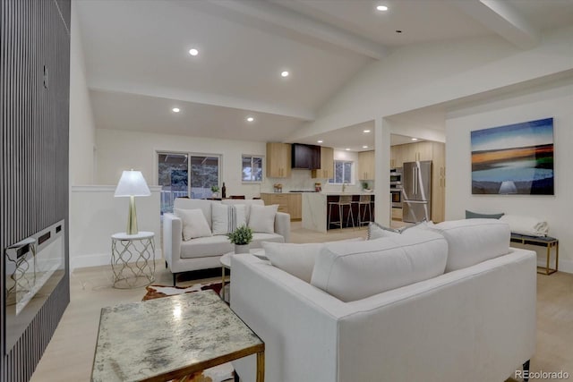 living room featuring beamed ceiling and high vaulted ceiling