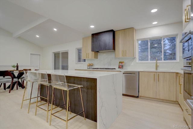 kitchen with backsplash, stainless steel dishwasher, wall chimney range hood, sink, and a kitchen island