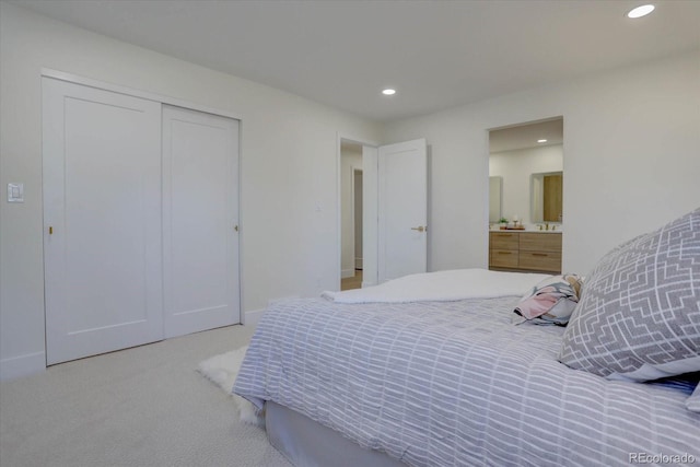 bedroom featuring light colored carpet and a closet