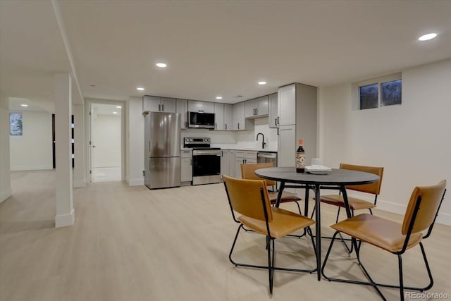 dining area with light hardwood / wood-style floors and sink