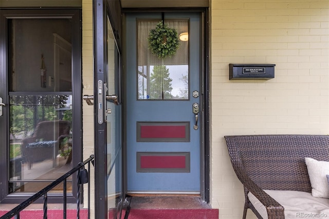 property entrance featuring concrete block siding