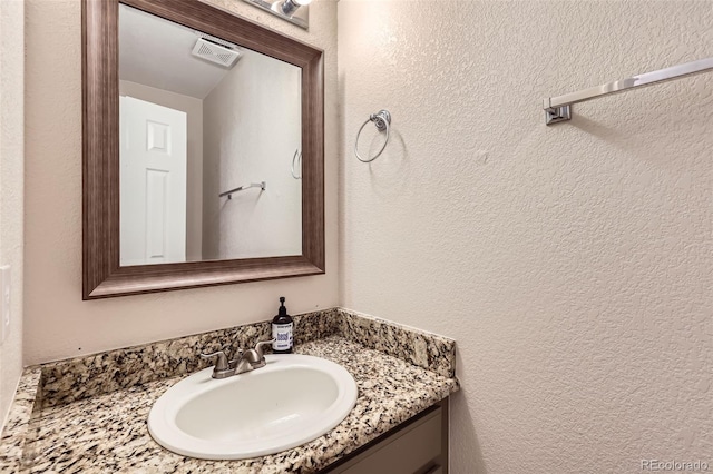 12701 Elm Ln, Broomfield, CO 80020 - bathroom featuring vanity and a textured wall