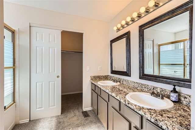 12701 Elm Ln, Broomfield, CO 80020 - bathroom featuring double vanity and baseboards