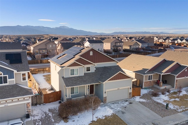 snowy aerial view featuring a mountain view