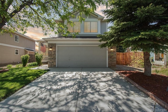 1462 Marigold Dr, Lafayette, CO 80026 - view of front facade featuring stone siding, an attached garage, and concrete driveway