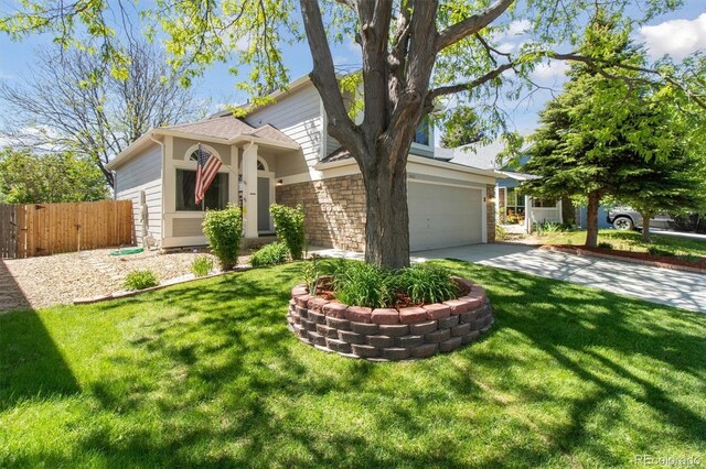 1462 Marigold Dr, Lafayette, CO 80026 - view of front facade with an attached garage, driveway, and stone siding