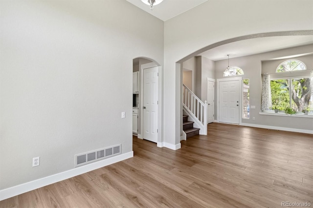 1462 Marigold Dr, Lafayette, CO 80026 - entrance foyer featuring arched walkways, baseboards, stairway, and wood finished floors