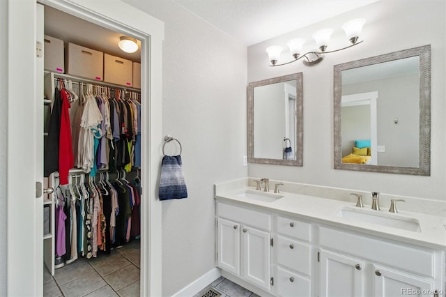 1462 Marigold Dr, Lafayette, CO 80026 - bathroom with tile patterned flooring, double vanity, baseboards, and a walk in closet