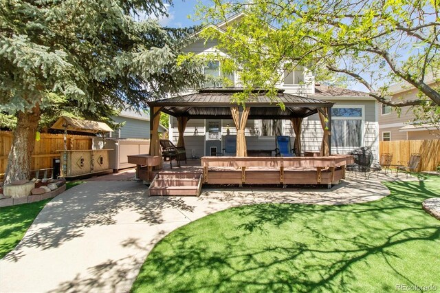 1462 Marigold Dr, Lafayette, CO 80026 - back of house with a gazebo, a patio area, a fenced backyard, a jacuzzi, and a standing seam roof