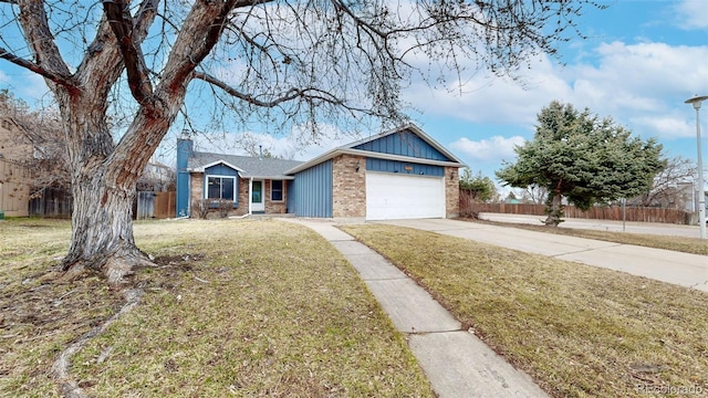 ranch-style home with driveway, fence, a front lawn, and brick siding