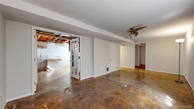 below grade area featuring ceiling fan and baseboards