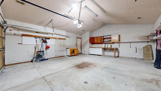 garage with visible vents and a garage door opener