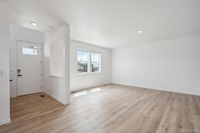 22363 E 6th Pl, Aurora, CO 80018 - entrance foyer with healthy amount of natural light, light wood-type flooring, and baseboards