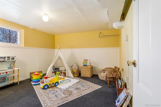 playroom with wainscoting and carpet