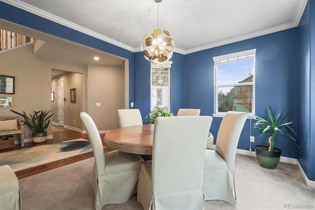 carpeted dining area with crown molding and baseboards