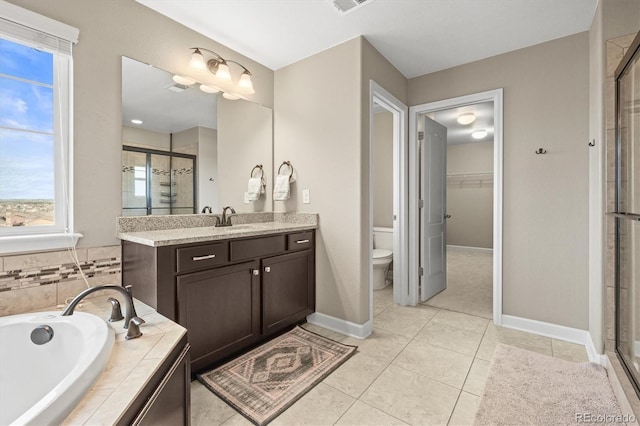 full bathroom with vanity, a bath, a stall shower, tile patterned flooring, and toilet